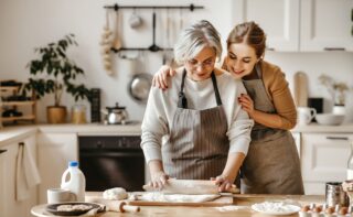 Grandmother And Grown Granddaughter Baking Together